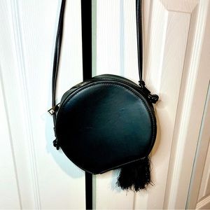 Black purse with tassel.